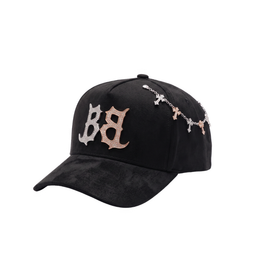Gorra Inferno negra con bordado frontal BB en pedreria plateada y rose gold, cadena lateral de cruces brillantes y visera negra texturizada